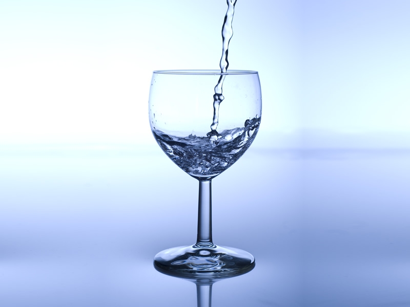 water pouring into clear stem glass