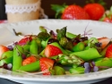asparagus and strawberries on a white plate