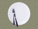 empty white dinner plate with knife and fork