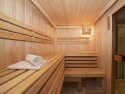 inside a wood-lined sauna with towels on the left