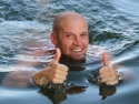 male swimmer in water giving two thumbs up gesture
