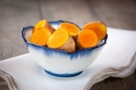 Fresh cut turmeric in a white bowl with blue trim