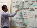 Tyler LeBaron at white board explaining H2 gas